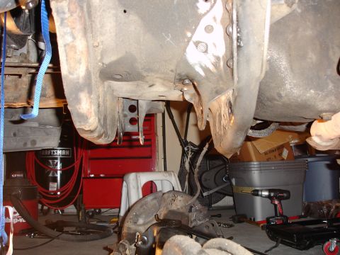 1996 Ford Bronco - Close-up view of the underbody and suspension components, showing signs of rust and wear.