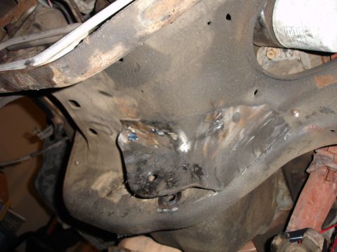 1996 Ford Bronco - Close-up view of a vehicle's undercarriage, showing recent welding work on the frame and a large oil filter.