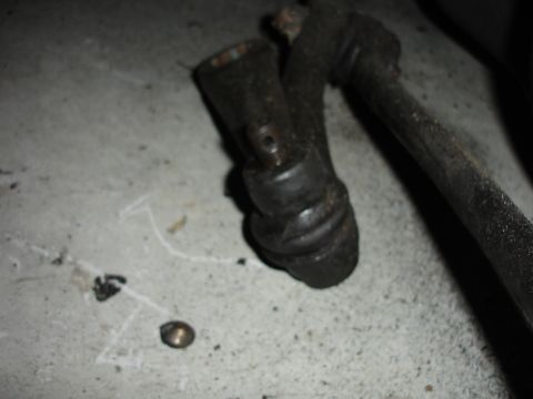 1996 Ford Bronco - Close-up of a worn ball joint and tie rod end, likely removed for replacement.
