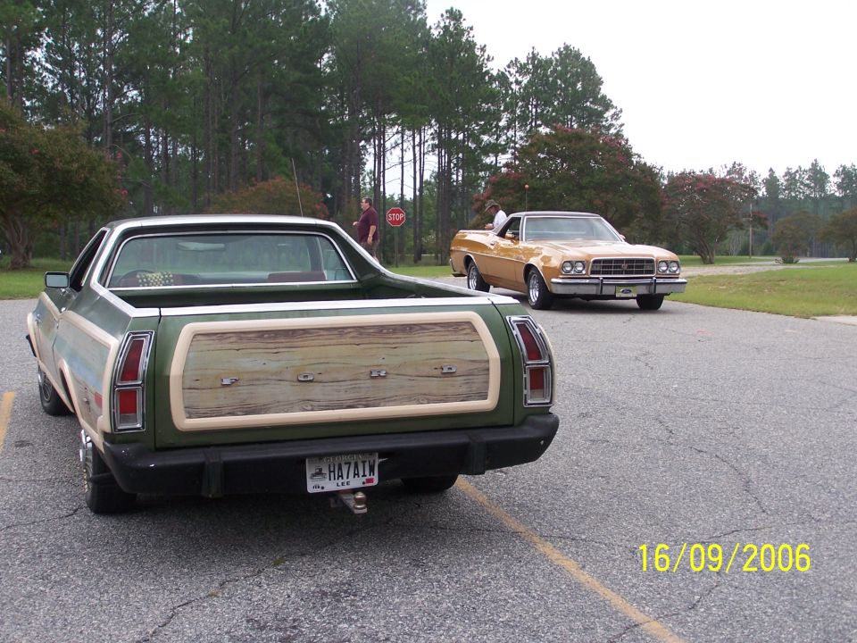 Green wood-trim Ford Ranchero and a gold Ranchero parked in a lot
