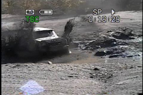 1989 Ford Bronco - This vehicle is navigating a muddy terrain, creating a significant splash.