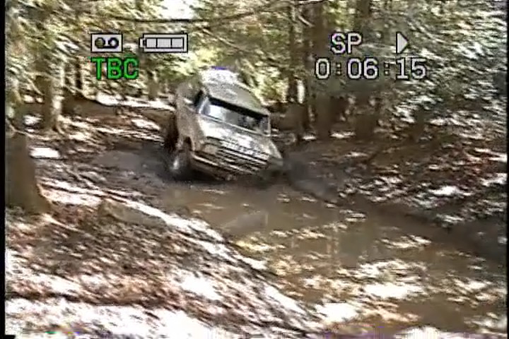 1989 Ford Bronco driving through mud
