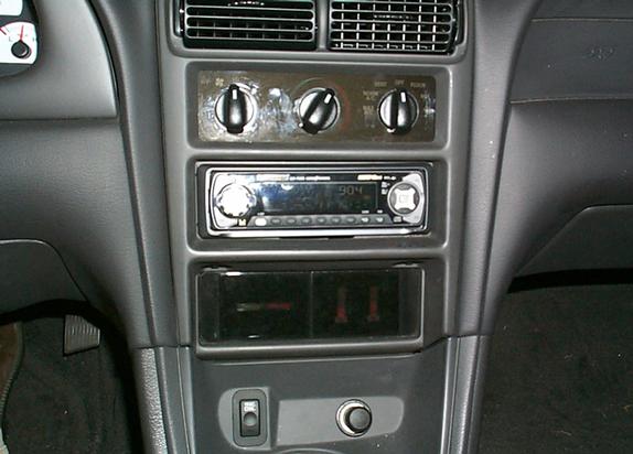 Interior dashboard of a 2000 Ford Mustang with aftermarket radio