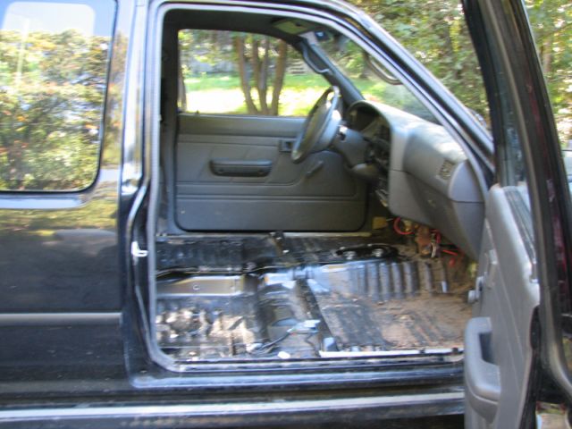 1994 Toyota Tacoma interior, driver's side door open, carpet removed