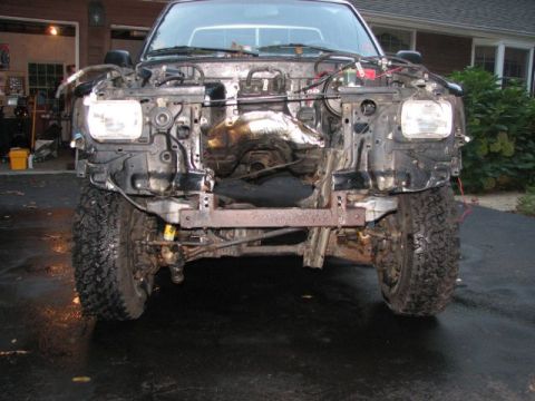 1994 Toyota Tacoma - The front of a truck is shown with its body panels removed, revealing the engine and chassis.