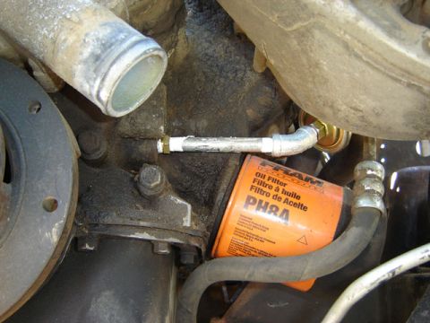 1971 Ford Bronco - An orange Fram oil filter is visible on the engine, alongside various hoses and metal components.