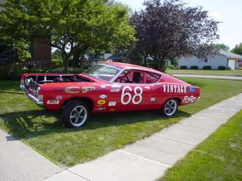 1968 Ford Torino - This red 1968 Ford Torino race car displays various decals and the number 68 on its side.