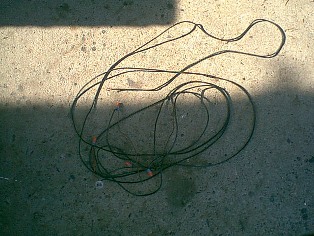 the PO ran wire from the pass side tail light to the drivers side tail light (same temp light socket in the lens deal and then under the bronco to the lowbeam headlight.