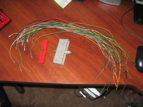 1991 Ford Bronco - A collection of electrical wires and connectors are laid out on a desk, likely for a vehicle repair or electronic project.