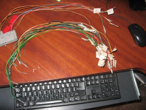1991 Ford Bronco - A complex wiring harness is spread out on a desk, with a keyboard and mouse visible nearby.
