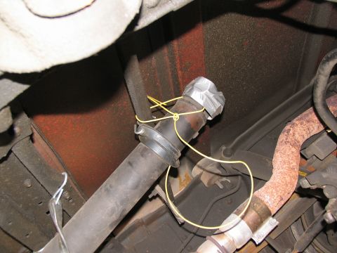 1988 Ford C-350 (Centurion Conversions) - Close-up view of the undercarriage, showing a driveshaft and exhaust system components.