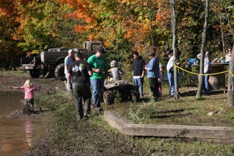 1987 Ford Bronco - Off-road gathering with multiple vehicles and people enjoying the autumn scenery.