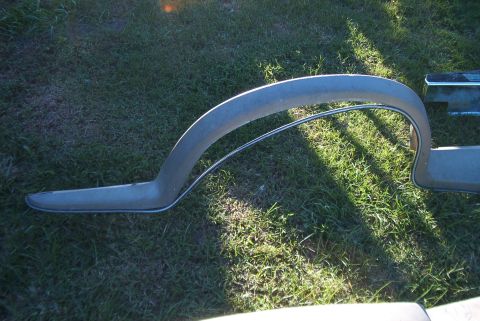 1988 Ford E250 - A single fender flare is shown from the side, resting on a grassy area.