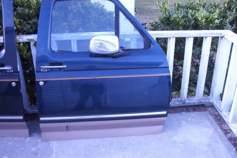 1988 Ford E250 - Pair of dark blue van doors with tan lower trim and chrome side mirrors are displayed outdoors.