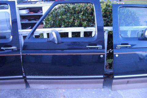 1988 Ford E250 - Dark blue Ford truck doors with tan lower panels and orange pinstripes are displayed side-by-side.