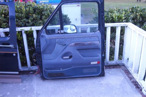 1988 Ford E250 - A detached car door interior panel is displayed outdoors.