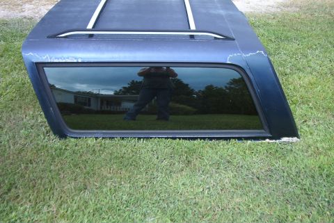 1988 Ford E250 - Truck cap with roof rack and tinted window, shown outdoors on grass.