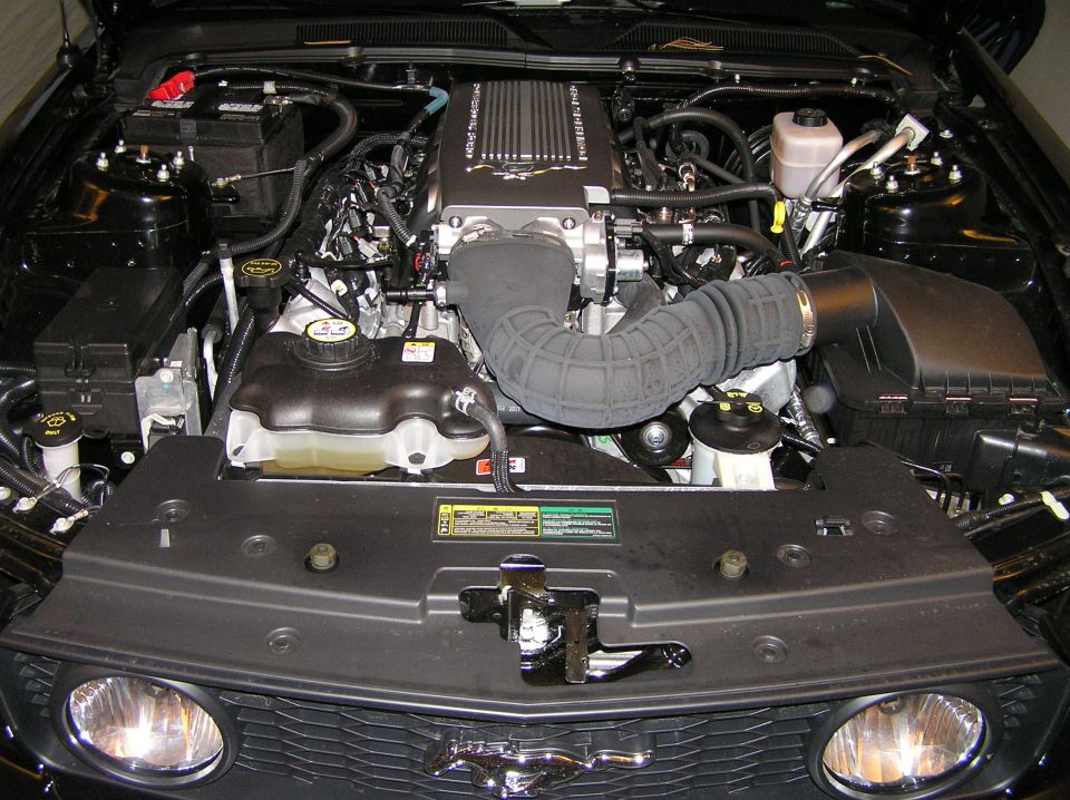 Ford Mustang engine bay with supercharger and air intake, viewed from front