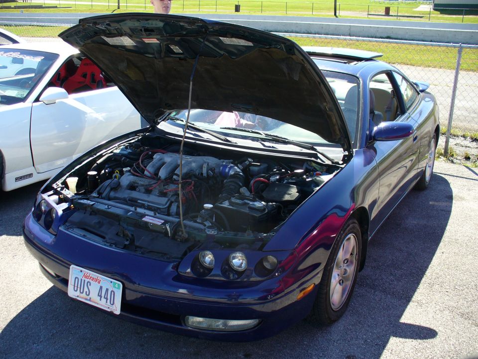 1991 Ford Probe with hood open, showing engine. Another white car is parked next to it