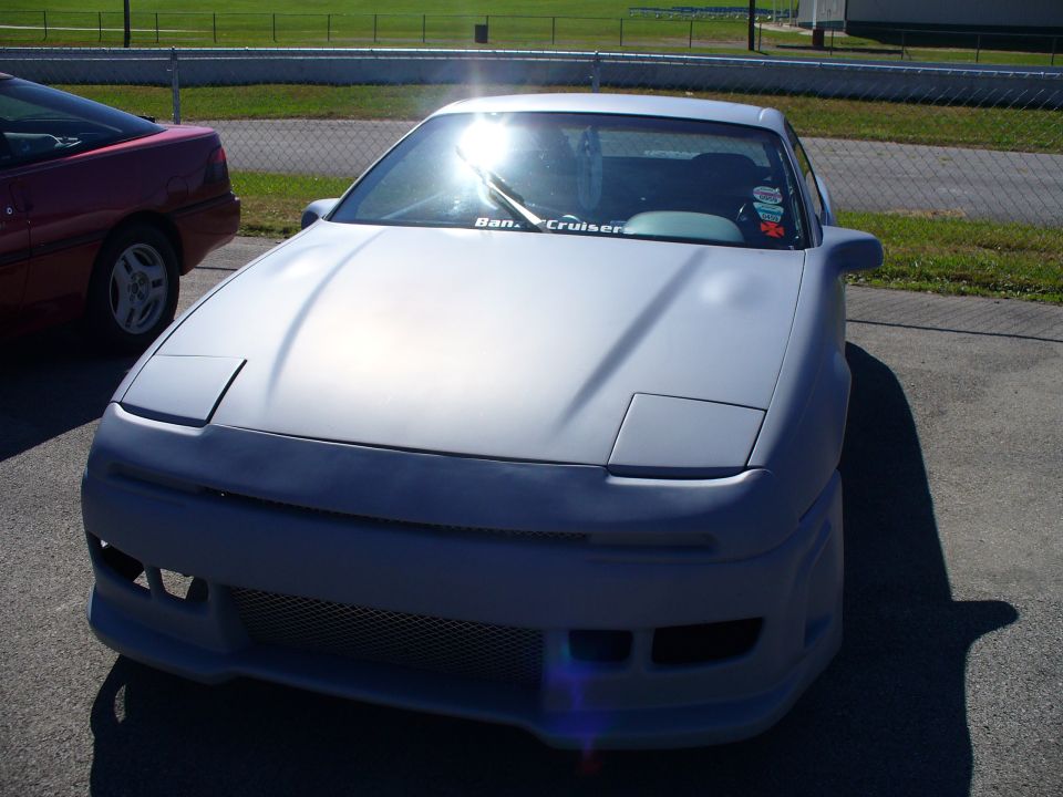 Gray 1991 Ford Probe with pop-up headlights and custom body kit
