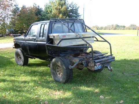 1985 Ford F-150 - This modified pickup truck features a custom roll cage and a toolbox mounted in the bed.