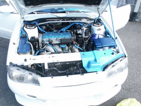 2001 Mercury Grand Marquis - The engine bay of a white car is visible with custom blue accents and hoses.