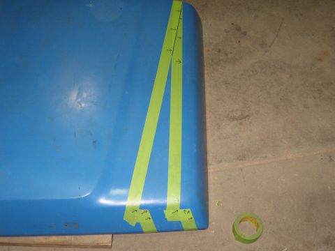1977 Ford F-150 - A blue panel with green tape and markings, possibly for a modification or repair.