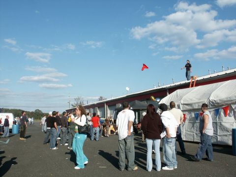 2001 Mercury Grand Marquis - An outdoor event is underway with many people milling about under a clear blue sky.