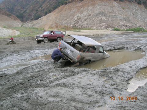 1985 Ford Bronco - Off-road vehicles stuck in mud after an outing. Date stamp reads 10.15.2006.