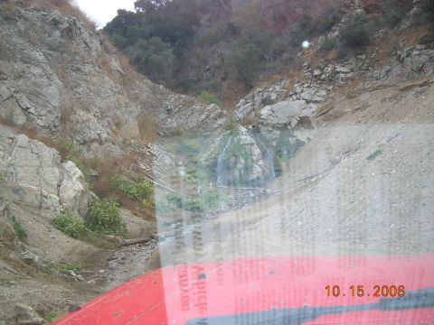 1985 Ford Bronco - View from a vehicle driving through a rocky canyon with a small waterfall, dated October 15, 2006.
