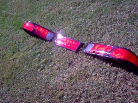 1994 Ford Probe - Car tail lights, possibly from a 1994 Ford Probe, are shown on grass.