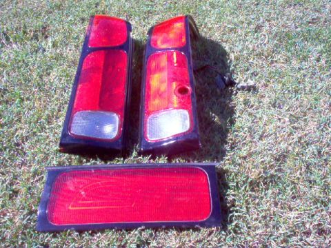 1994 Ford Probe - These are three separate car tail light assemblies shown on a grassy surface.