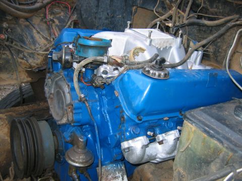 1992 Ford Mustang - Close-up view of a blue painted engine in an engine bay, focusing on various engine components.