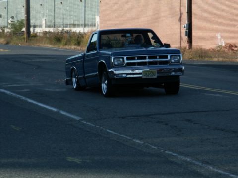 2001 Mercury Grand Marquis - Blue pickup truck with chrome accents driving on a road, license plate visible.
