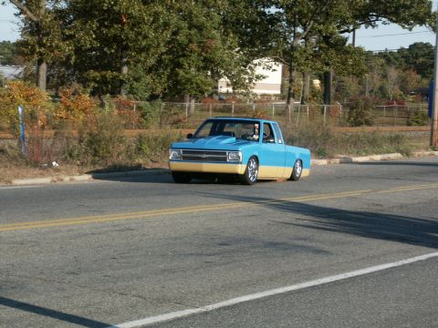 2001 Mercury Grand Marquis - A custom pickup truck with a two-tone paint job is seen driving down the road.