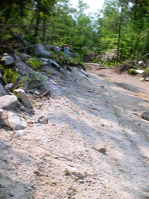2001 Ford Escape - A dirt trail passes through a rocky, wooded landscape.