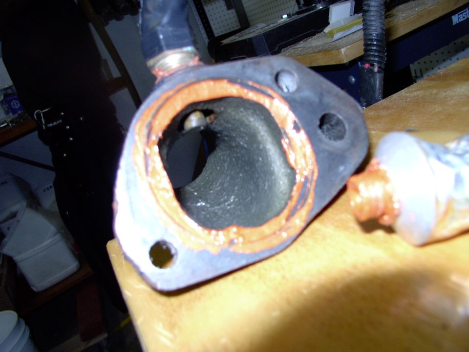 Lay a bit of sealant on the inside of the now cleaned T-stat housing locating indent. I use Permatex Ultra-Copper on everything under the hood, because it's high heat and sensor safe.