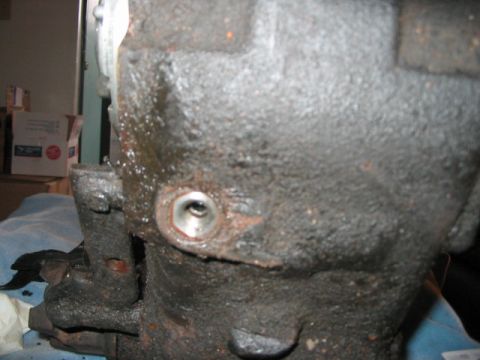 1991 Ford Bronco - Close-up of a greasy, cast-iron mechanical part with a threaded hole visible.