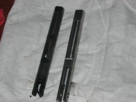 1991 Ford Bronco - Two metal shafts are shown on a white cloth, one with visible wear and damage at its end.
