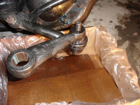1996 Ford Bronco - A close-up view of a vehicle's steering linkage component, showing part number markings.