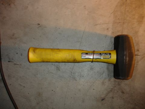 1996 Ford Bronco - Sledgehammer with yellow handle and black head, labeled STANLEY 36/14g.