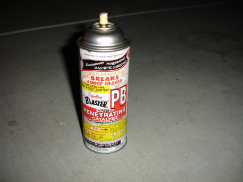 1996 Ford Bronco - A can of PB Blaster penetrating catalyst sits on a concrete floor.