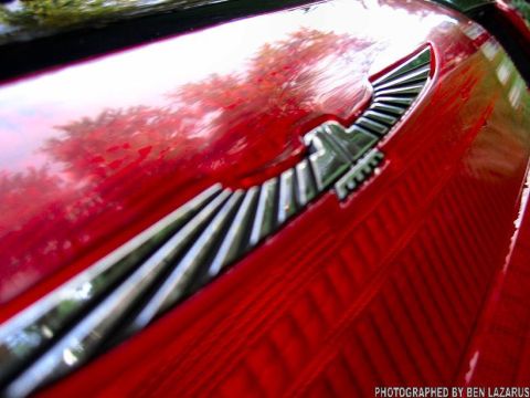 1997 Ford Thunderbird - Close-up of a red car's emblem, identified as a 1997 Ford Thunderbird.