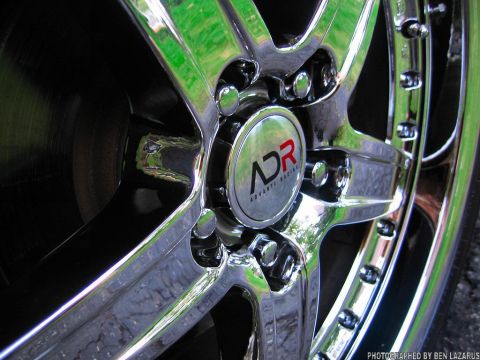 1997 Ford Thunderbird - Close-up of a chrome wheel with an ADR Advanti Racing center cap.