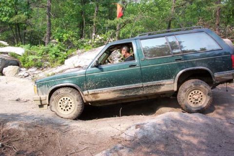 2001 Ford Escape - My dad in his stock Chebby, flexing on a rock step.