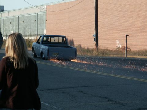 2001 Mercury Grand Marquis - Pickup truck is throwing sparks as it drives down the road.