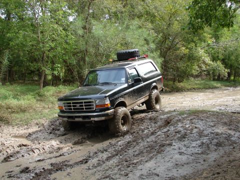 1996 Ford Bronco - This 1996 Ford Bronco navigates a challenging muddy terrain, its off-road capabilities.
