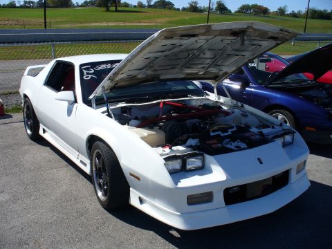 1991 Ford Probe - A white coupe with its hood open, revealing the engine compartment, parked outdoors.
