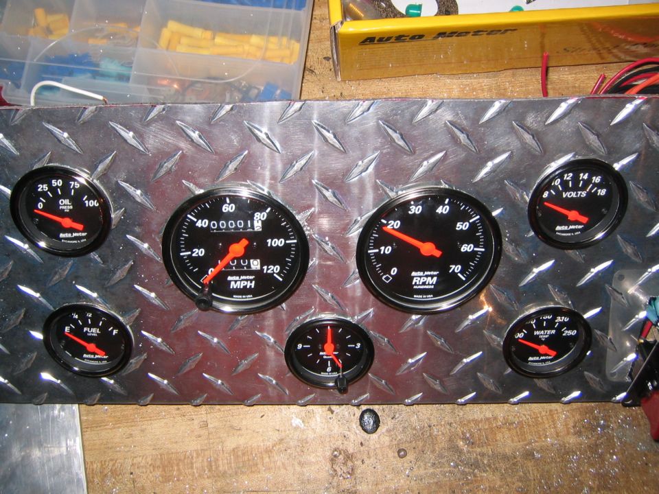 Diamond plate panel with gauges: oil pressure, speedometer, tachometer, fuel, volts, and water temp