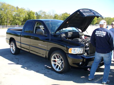 1991 Ford Probe - A black Dodge Ram SRT-10 pickup truck is shown with its hood open, revealing the engine bay.